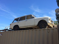 Quickie: Datsun 411 Wagon Roller on Top of a Shipping Container